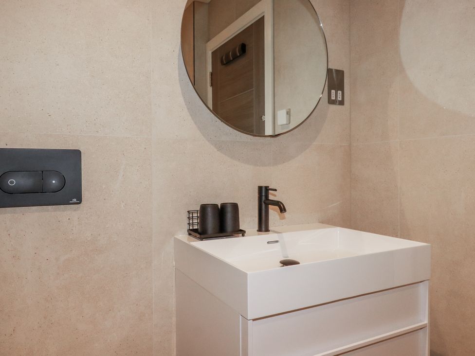 A bathroom with a sink and mirror at 13 Cliff Edge in Newquay