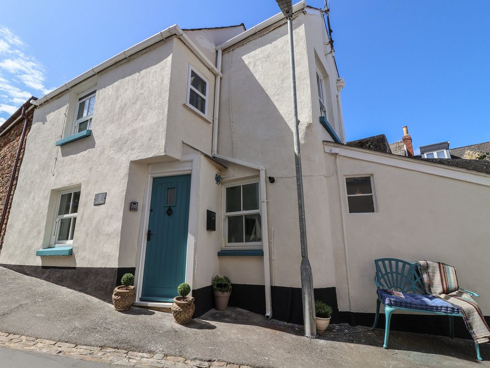 A house with a turquoise door and plants at Honeymoon Cottage in Appledore