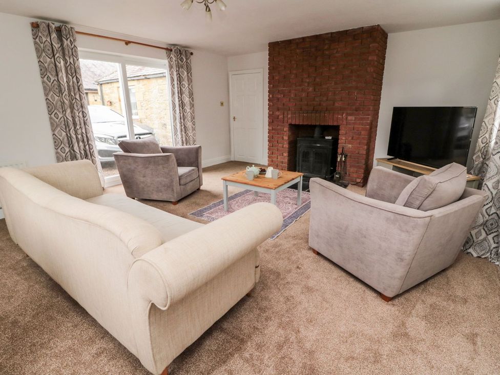 A living room with a sofa and armchairs at Whinney Moor
