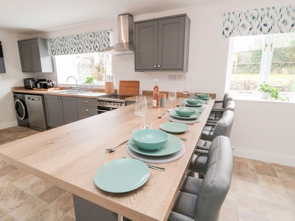 A kitchen with a dining table set at Whinney Moor