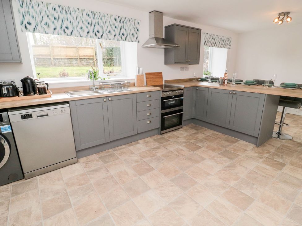 A kitchen with appliances and dining area at Whinney Moor in 
