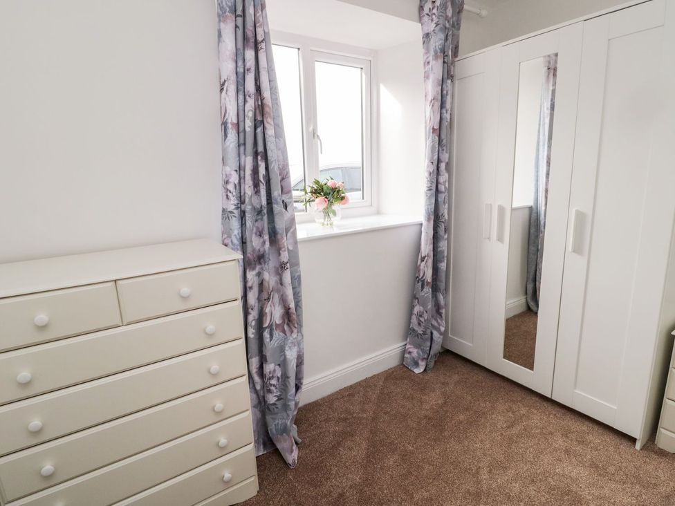 A bedroom with a dressing table and a wardrobe at Whinney Moor