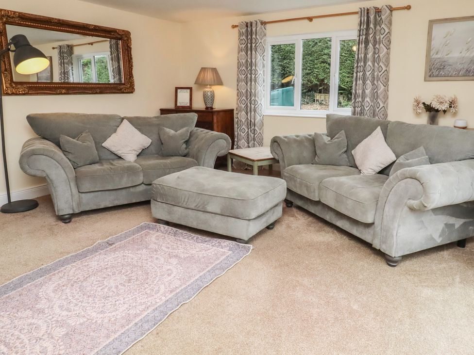 A living room with sofas and a decorative rug at Whinney Moor in Alnwick