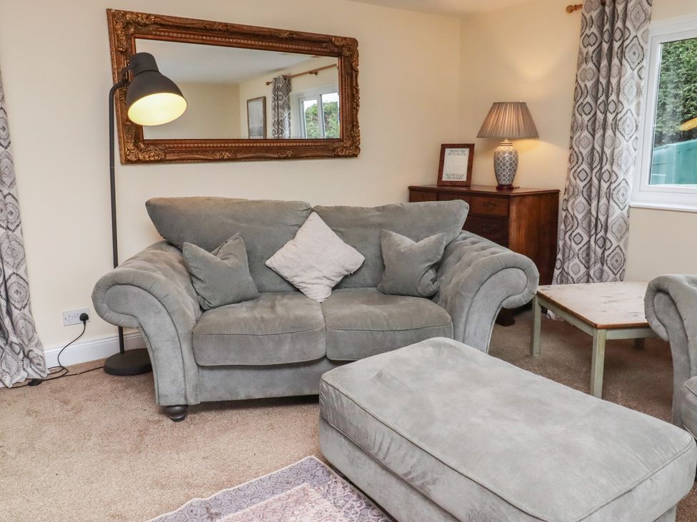 A living room with a sofa and a lamp at Whinney Moor in Alnwick