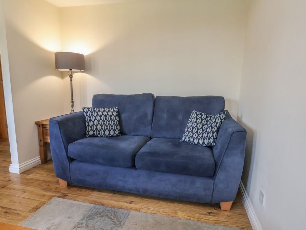 A living room with a sofa and lamp at Bugle, Saltburn-By-The-Sea