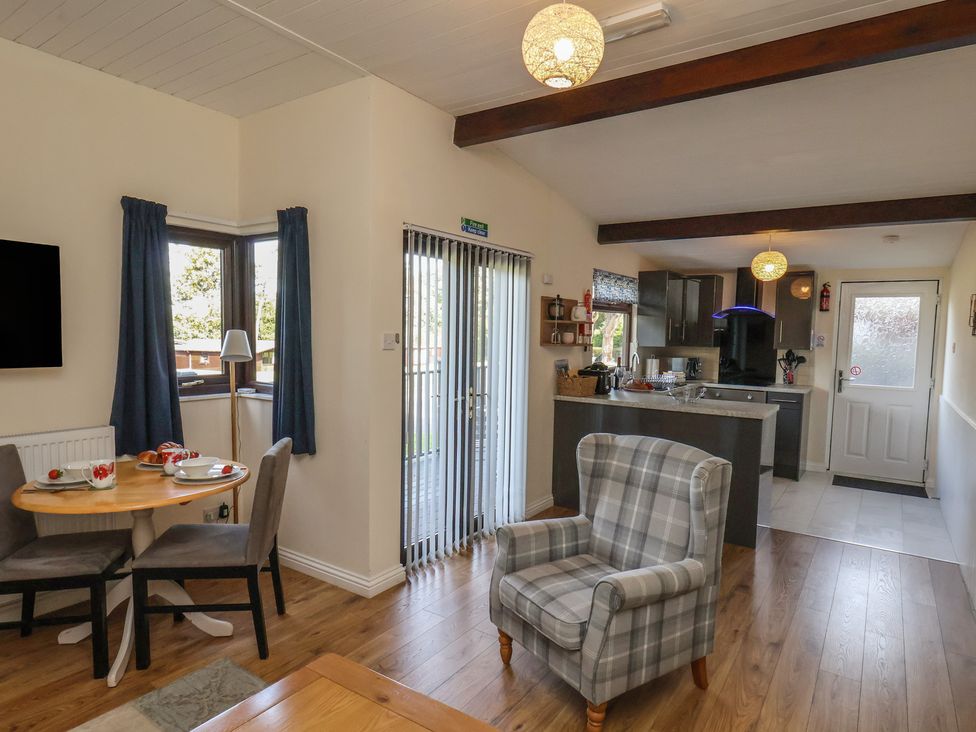 A living room with a dining table and kitchen area at Bugle in Saltburn-By-The-Sea