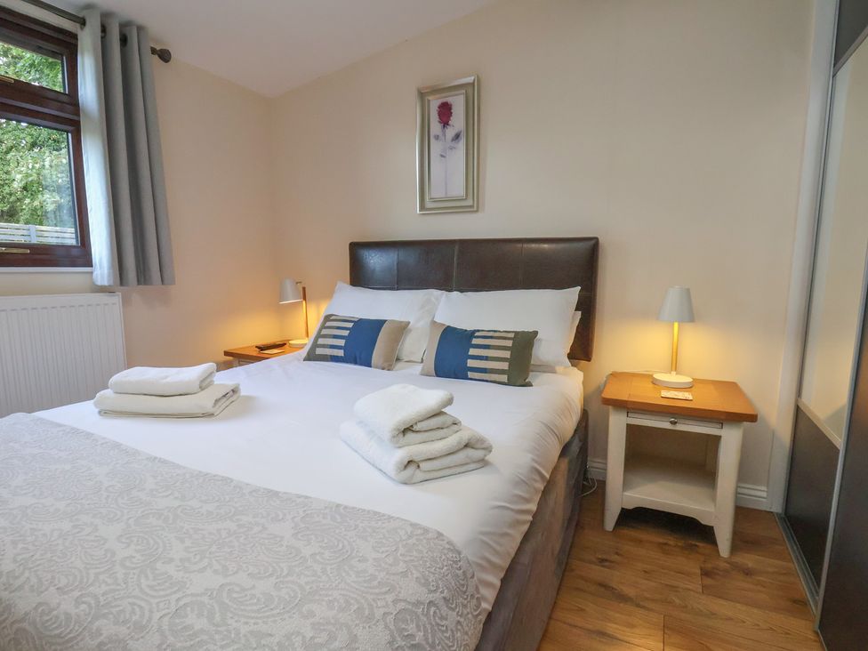 A bedroom with a bed and bedside tables at Bugle in Saltburn-By-The-Sea