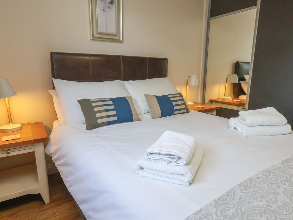 A bedroom with a bed and bedside tables at Bugle Saltburn-By-The-Sea