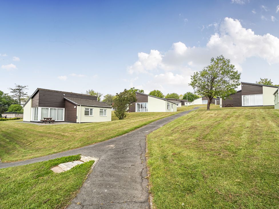 View of bungalows and grass area at Harcombe House Pet Friendly Bungalow in Chudleigh
