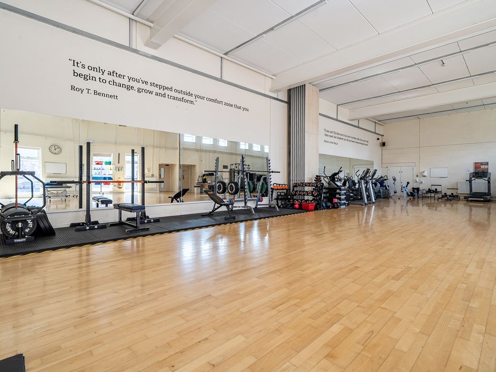 A gym with exercise equipment and mirrors at Harcombe House Pet Free Bungalow in Chudleigh