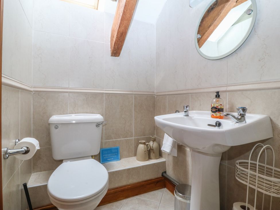 A bathroom with a sink and toilet at Beudy Penarddwnion Rhydymain near Dolgellau