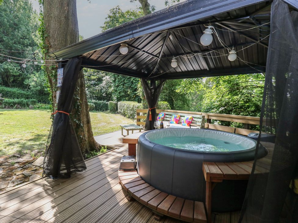 An outdoor area with a hot tub and seating at Glebe House in Dalton-le-Dale near Murton, County Durham
