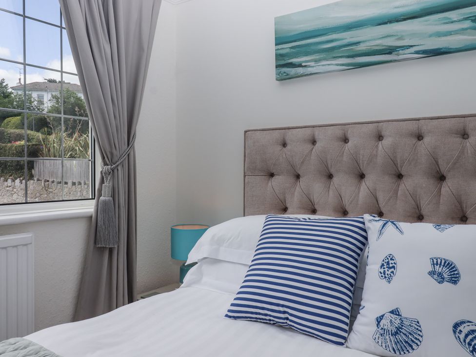 A bedroom with a bed and window at Kinbrae Apartment in Torquay