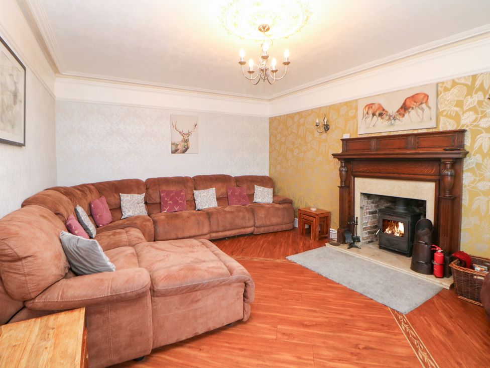 A living room with a sofa and fireplace at The Old Post Office Wirksworth