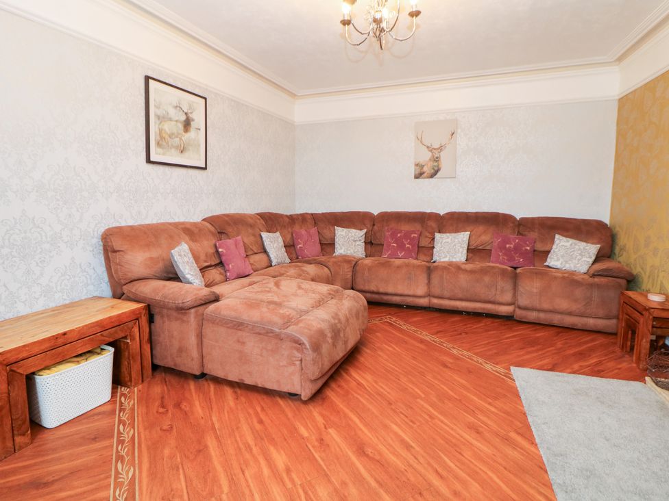 A living room with a large sofa and coffee table at The Old Post Office in Wirksworth