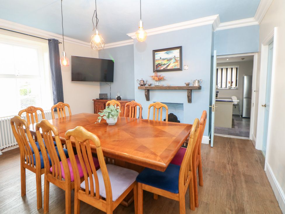 A dining room with a table and chairs at The Old Post Office in Wirksworth
