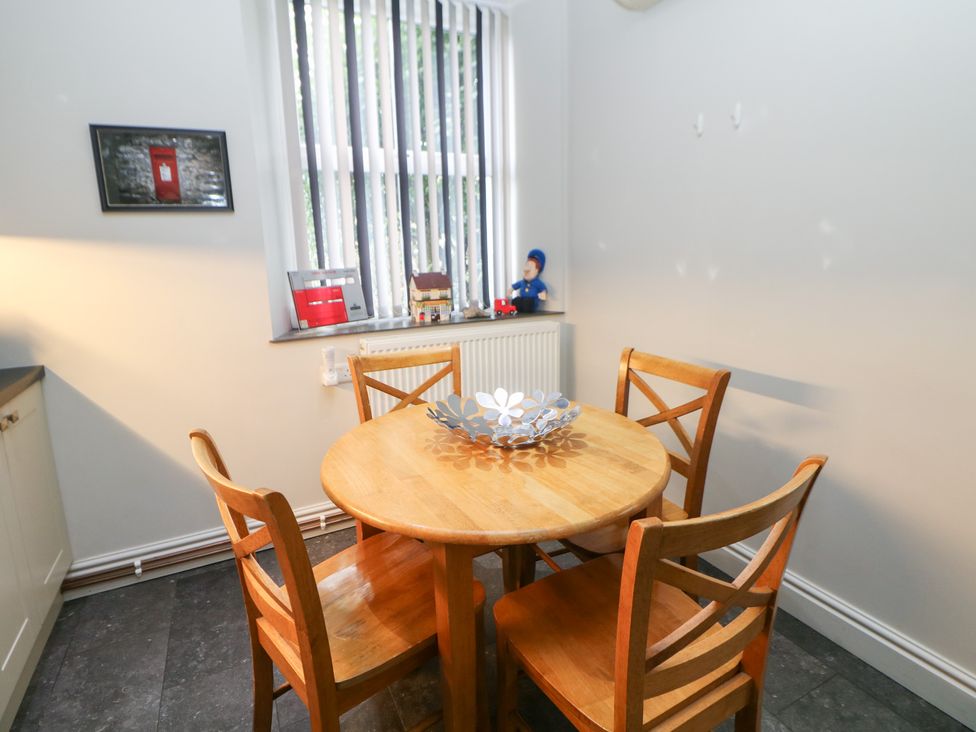 A kitchen with a table and chairs at The Old Post Office Wirksworth