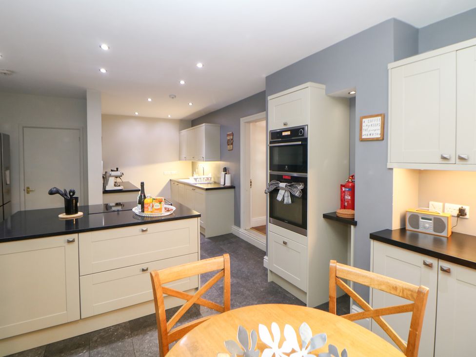A kitchen with a table and chairs at The Old Post Office in Wirksworth