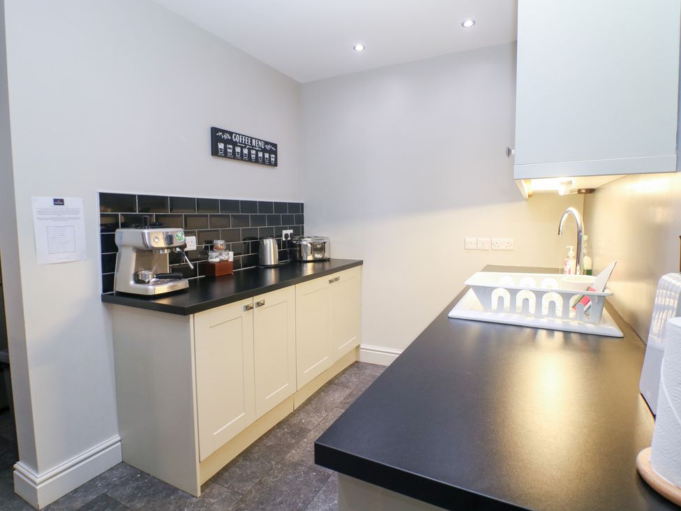 A kitchen with a coffee machine and kettle at The Old Post Office in Wirksworth