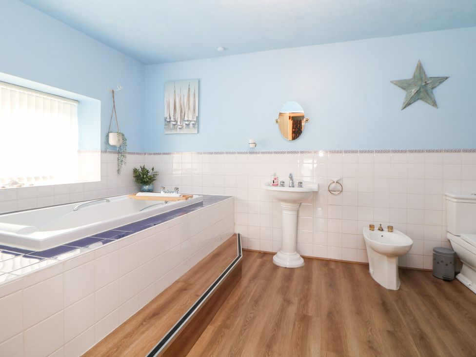A bathroom with bathtub, sink, and toilet at The Old Post Office in Wirksworth