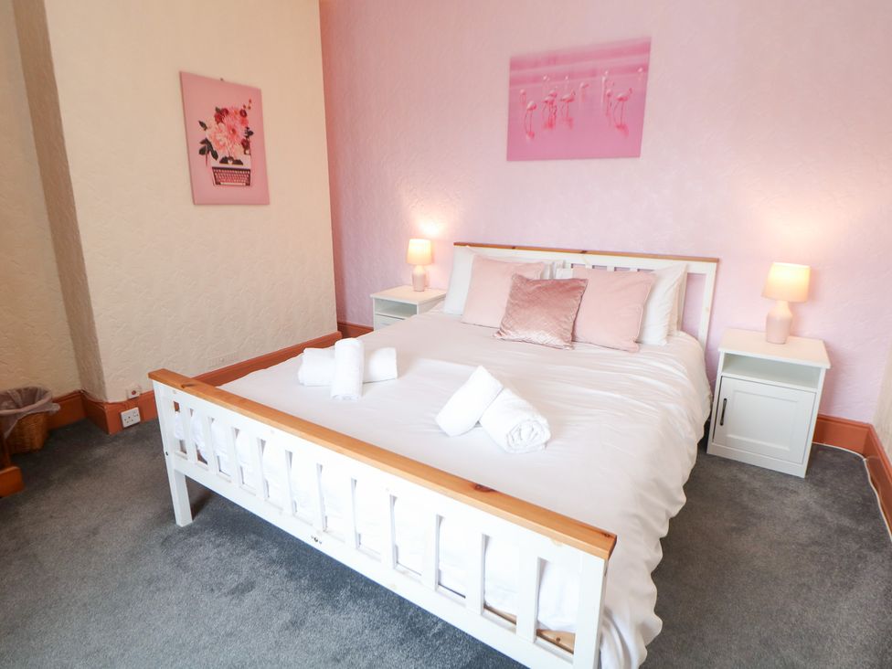A bedroom with a bed and nightstands at The Old Post Office in Wirksworth