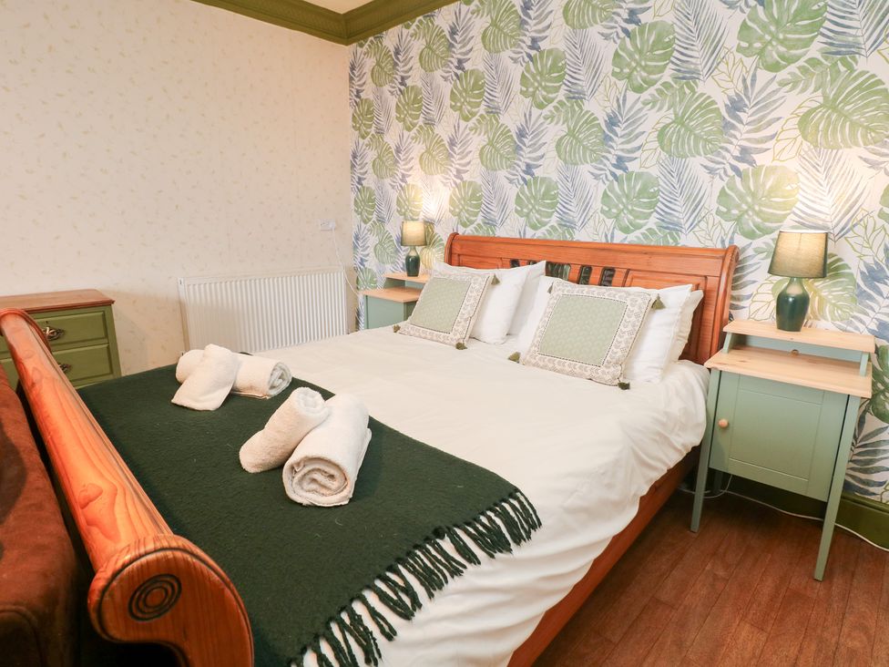 A bedroom with a double bed and bedside tables at The Old Post Office in Wirksworth