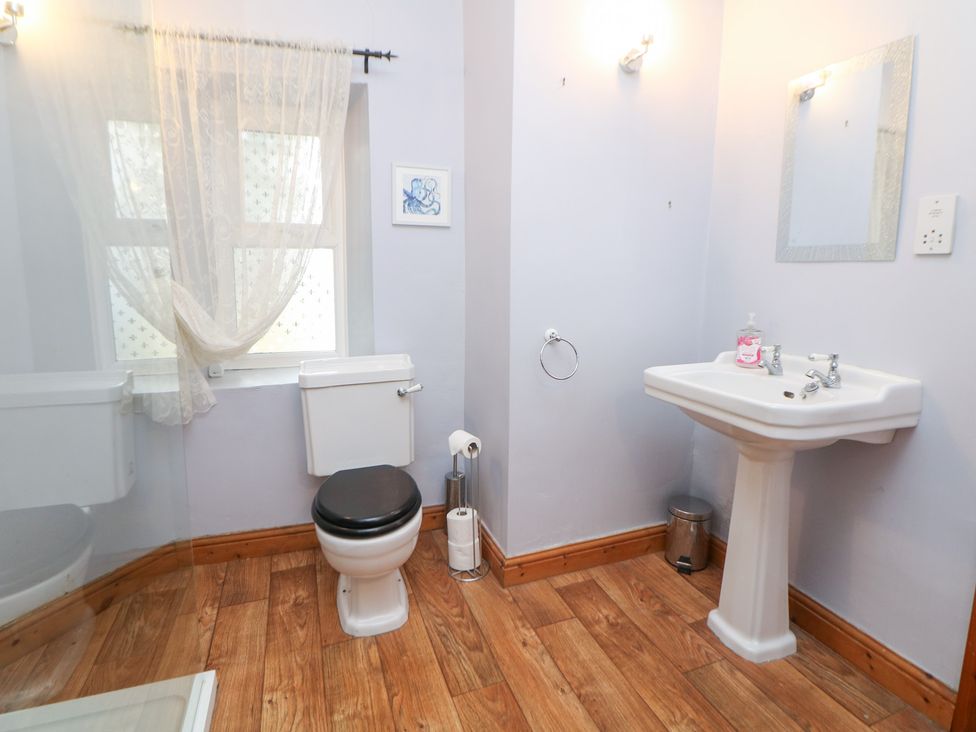 A bathroom with a toilet and sink at The Old Post Office Wirksworth
