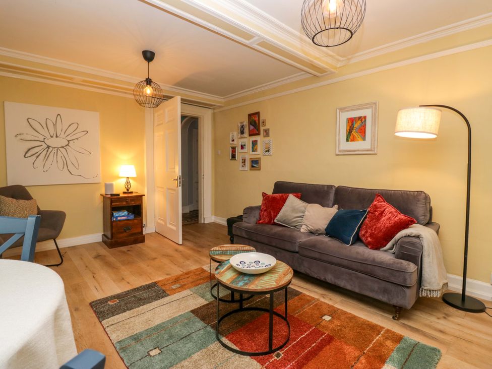 A living room with a sofa and coffee table at 1 Tower House in Cartmel