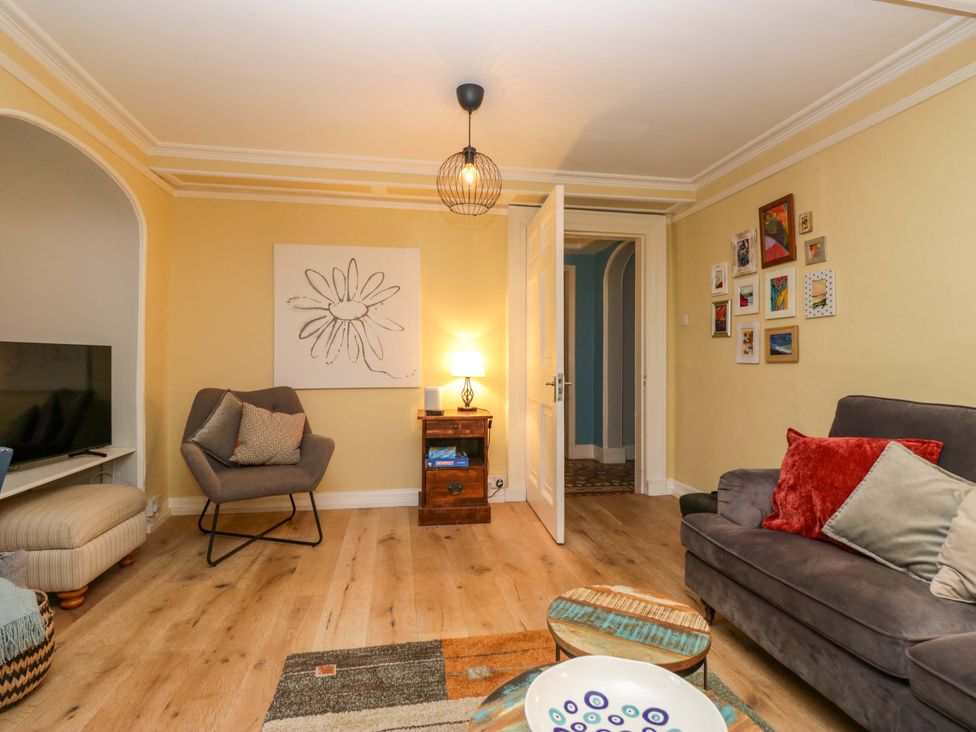 A living room with a television and seating area at 1 Tower House in Cartmel