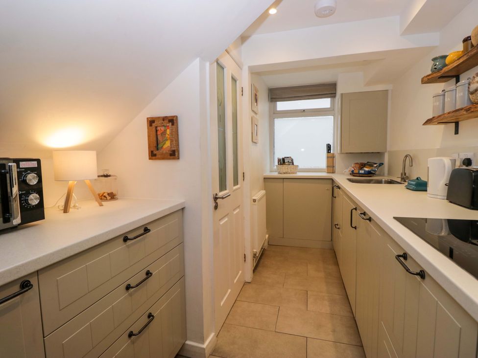 A kitchen with a sink and cupboards at 1 Tower House Cartmel