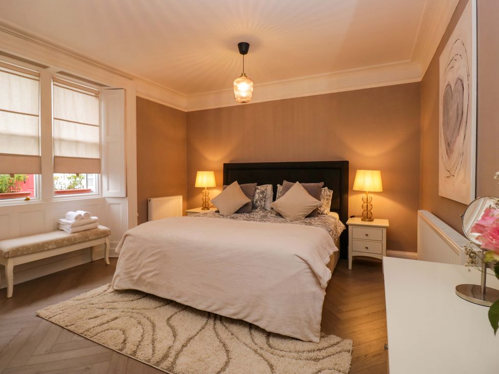 A bedroom with a bed and lamps at 1 Tower House in Cartmel