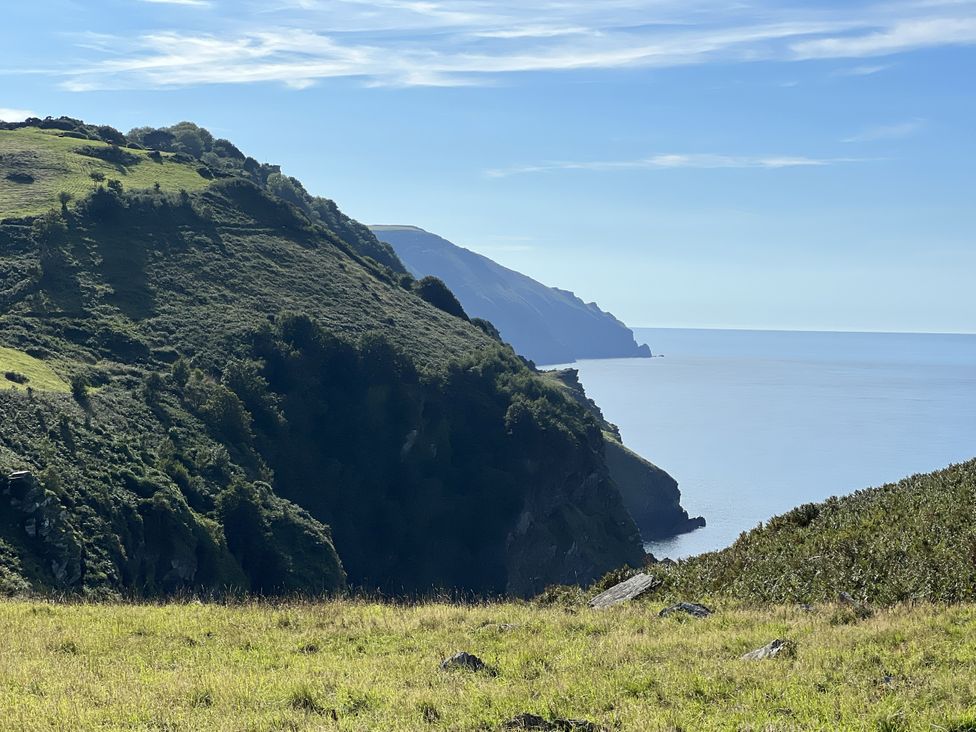 A coastal view with hills and ocean at Oak Cottage in North Molton