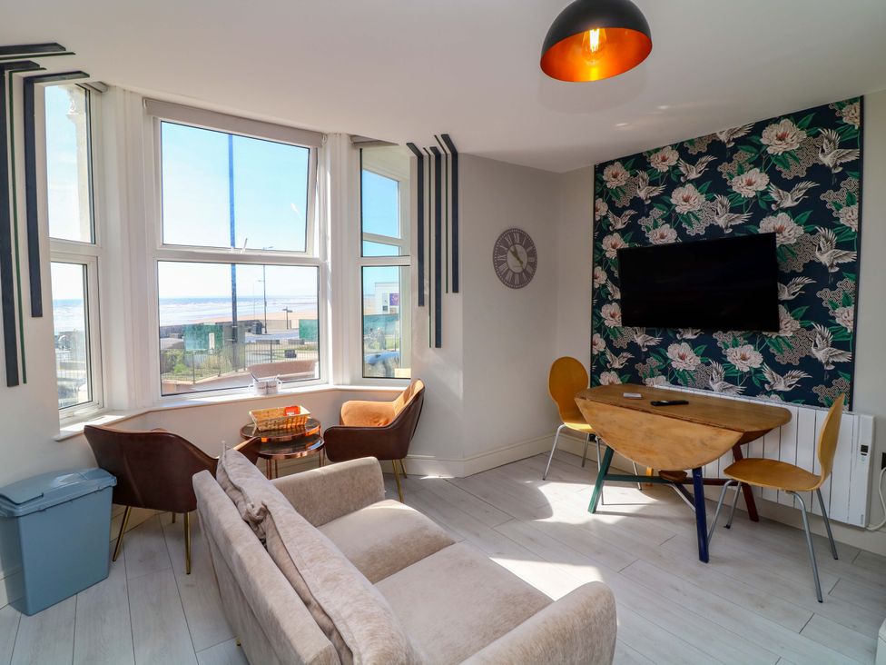 A living room with a table and sofa at Apt 4 @ Hunter's Quay Bridlington