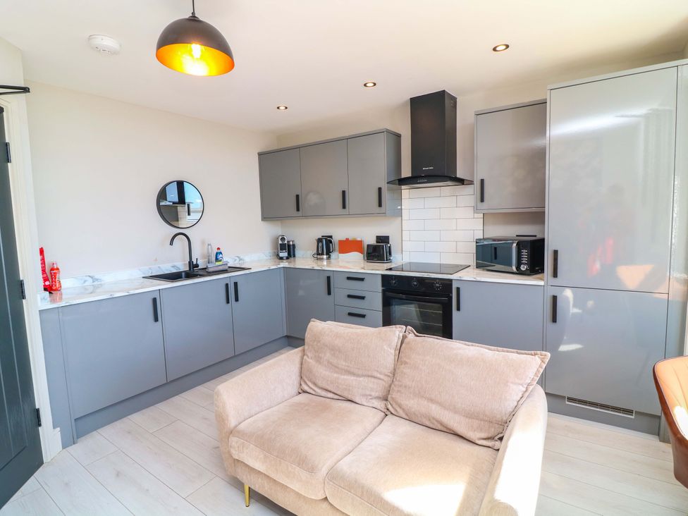 A kitchen with grey cabinets and appliances at Apt 4 @ Hunter's Quay Bridlington