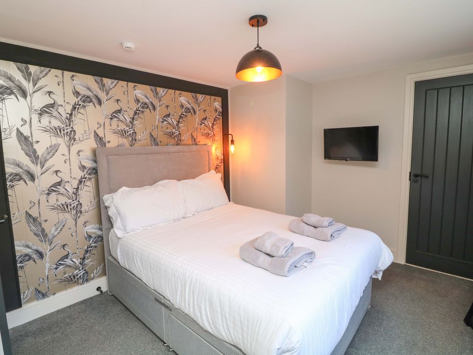 A bedroom with a bed and towels on a surface at Apt 4 @ Hunter's Quay in Bridlington