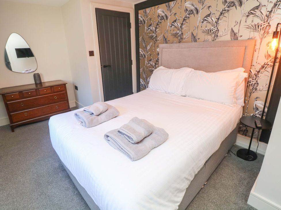 A bedroom with a bed and dresser at Apt 4 @ Hunter's Quay in Bridlington