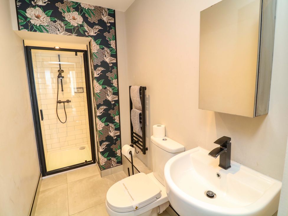 A bathroom with a shower, sink, and toilet at Apt 4 @ Hunter's Quay, Bridlington