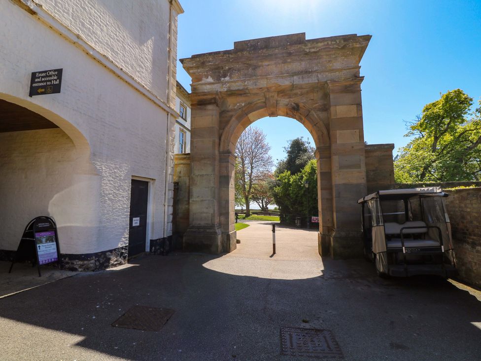 An archway entrance with a sign and golf cart at Apt 4 @ Hunter's Quay Bridlington