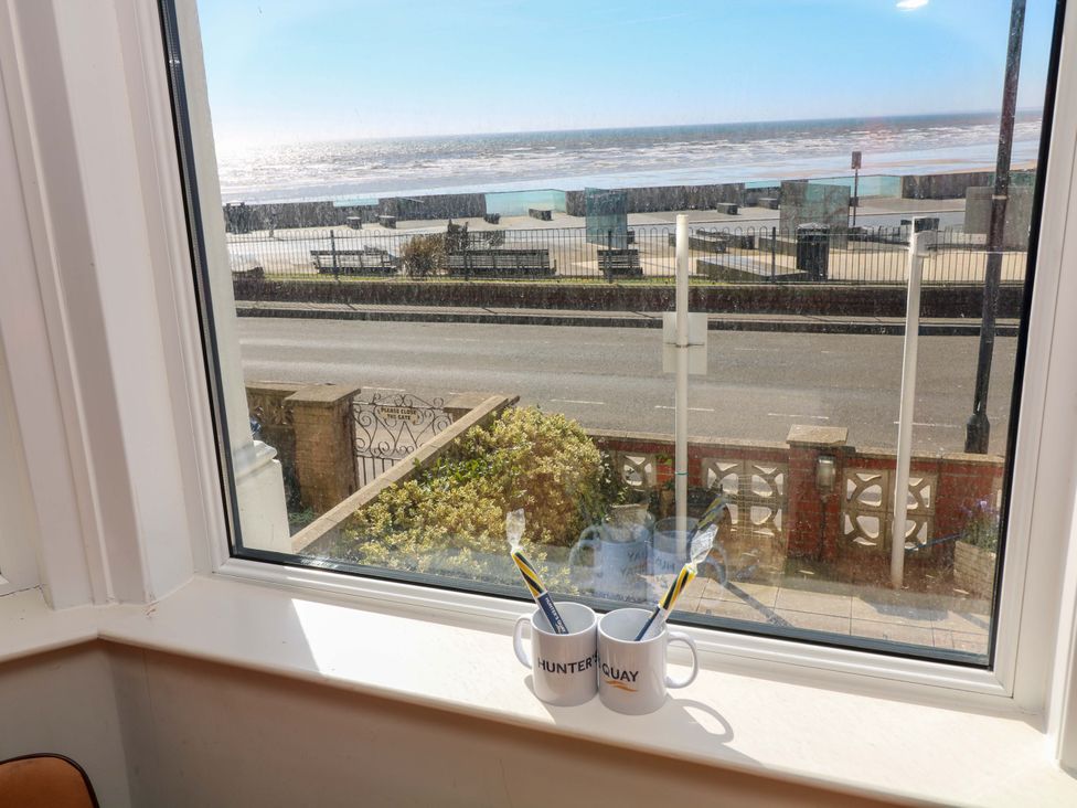 A living room window with mugs overlooking the ocean at Apt 4 @ Hunter's Quay Bridlington
