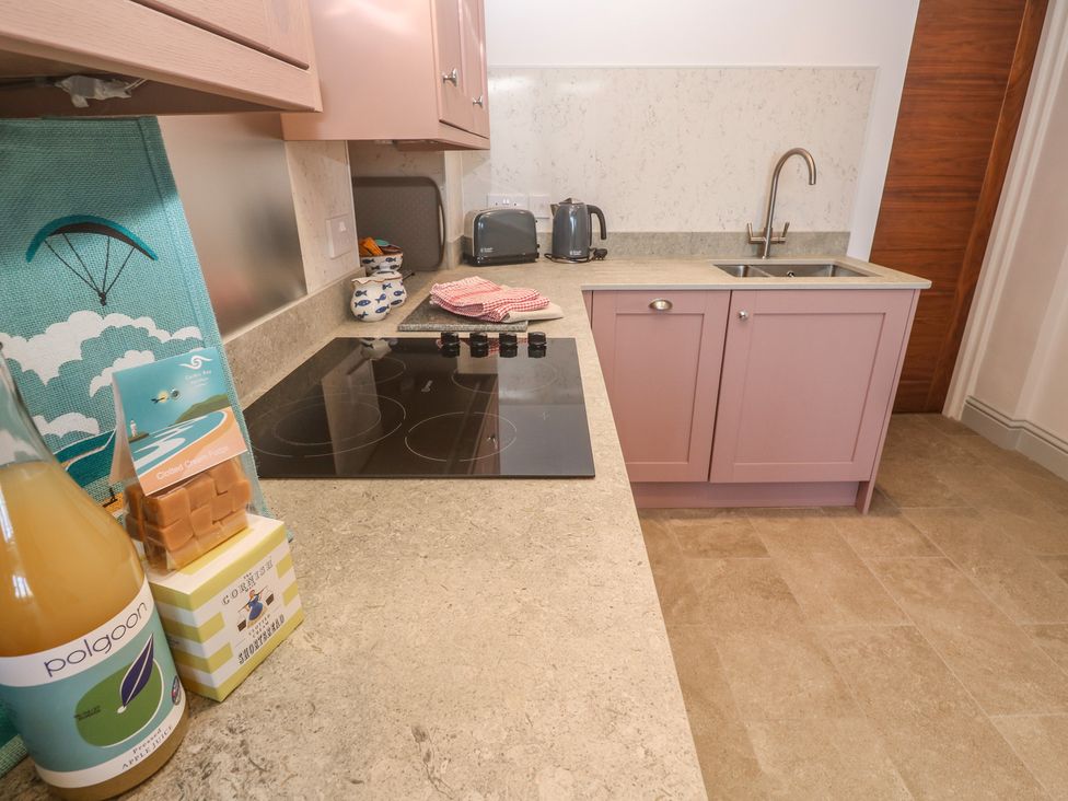 A kitchen with cabinets and appliances at Heron in St Ives