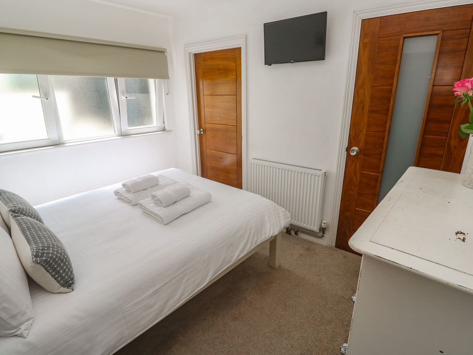 A bedroom with a bed and towels on it at Heron St Ives