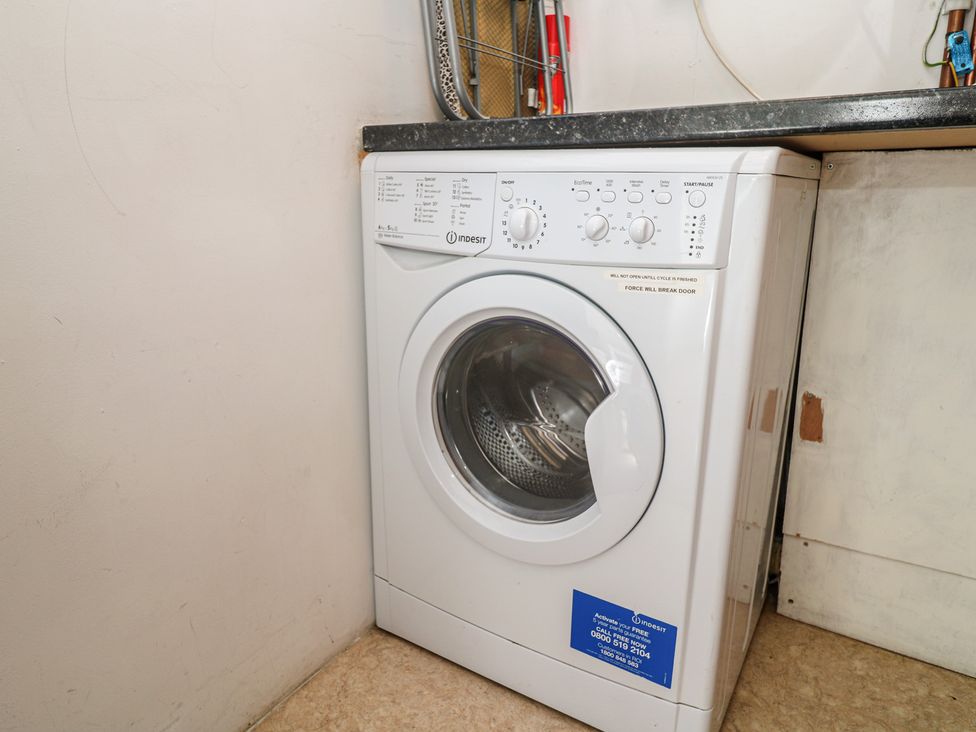 A washing machine in a laundry room at Heron St Ives