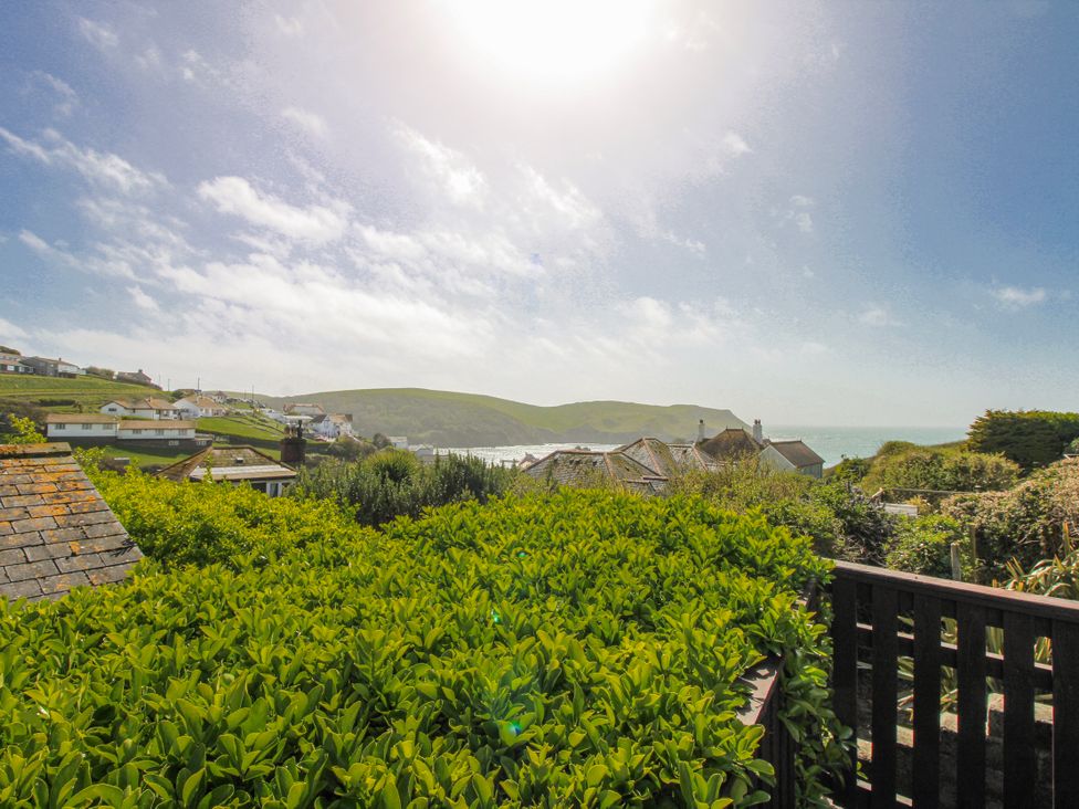 A scenic view of hills and sea from a garden at Eddystone in Hope Cove