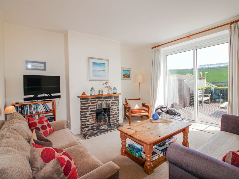 A living room with a sofa and television at Eddystone in Hope Cove