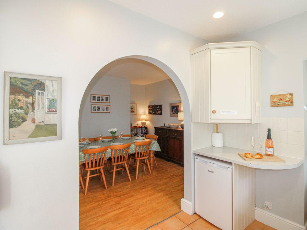 A kitchen with a dining area and appliances at Eddystone in Hope Cove