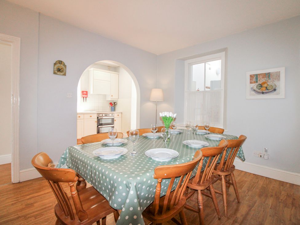 A dining room with a table and chairs at Eddystone in Hope Cove