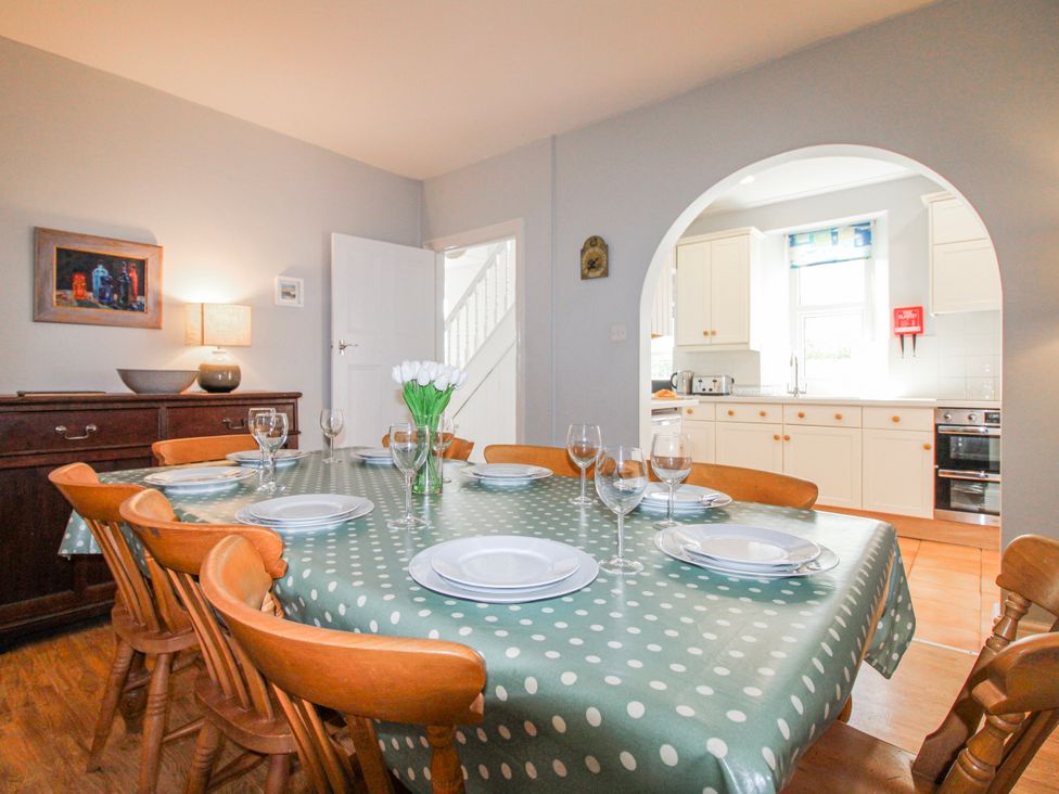 A dining room with a table set for a meal at Eddystone in Hope Cove