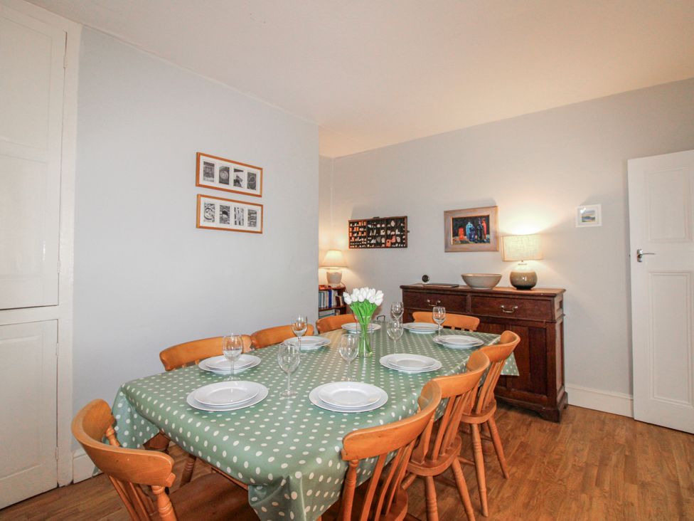 A dining room with a table set for dinner at Eddystone in Hope Cove