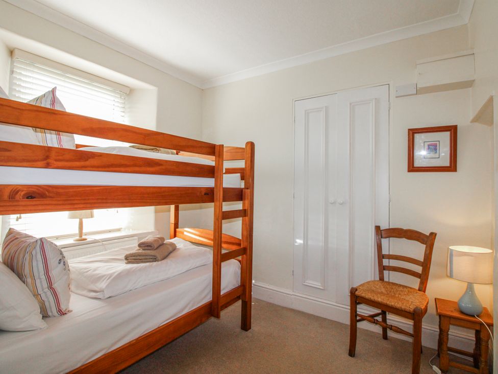 A bedroom with a bunk bed and a single bed at Eddystone in Hope Cove