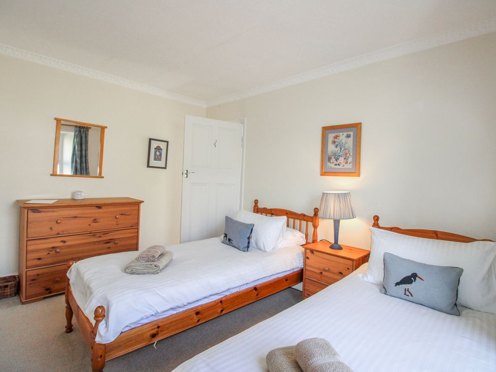 A bedroom with two single beds and a dresser at Eddystone in Hope Cove